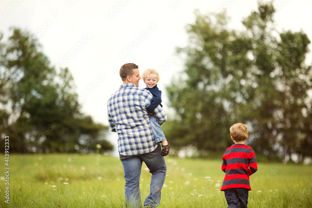 Happy father with sons on grassy field Happy father with sons on grassy field