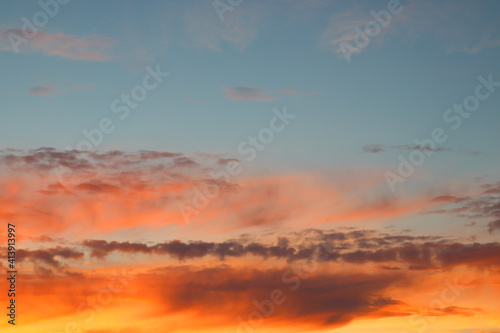 Beautiful sunset sky with clouds of orange and yellow. Natural background