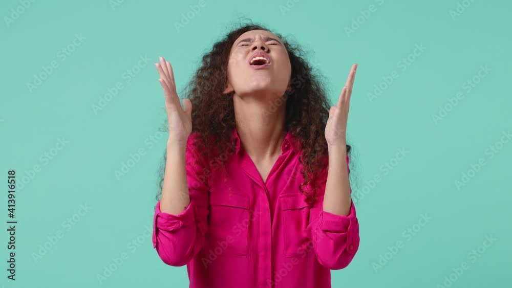 Joyful young african american woman 20s in pink shirt isolated on blue turquoise background studio. People lifestyle concept. Count countdown 1 2 3 one two three doing winner gesture clenching fists Joyful young african american woman 20s in pink shirt isolated on blue turquoise background studio. People lifestyle concept. Count countdown 1 2 3 one two three doing winner gesture clenching fists