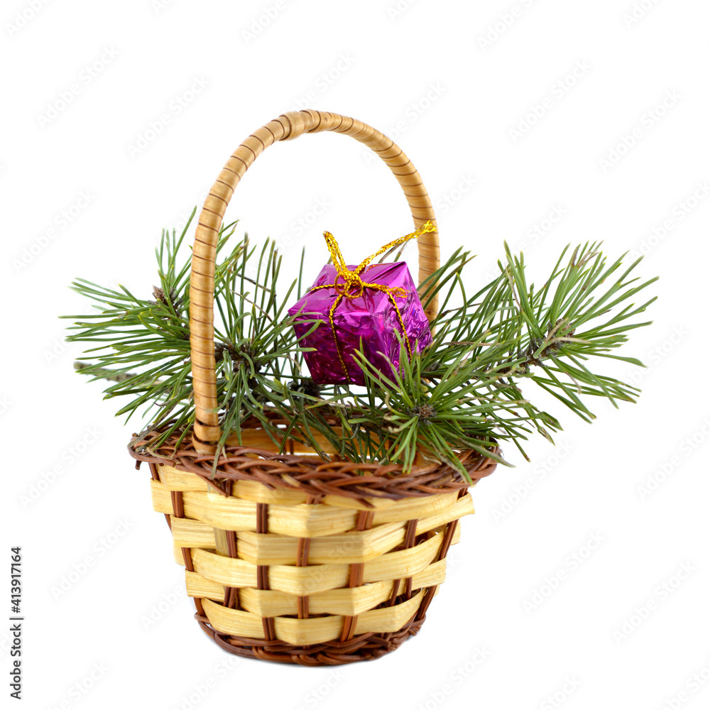 Basket with a branch of spruce and a bright gift. Basket with a branch of spruce and a bright gift.