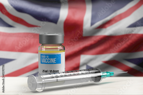 National Covid-19 vaccine concept: 3d rendered medical injection vial and syringe with moving British Union Jack flag in background. Country competition and fight against pandemic. Health care crises photo