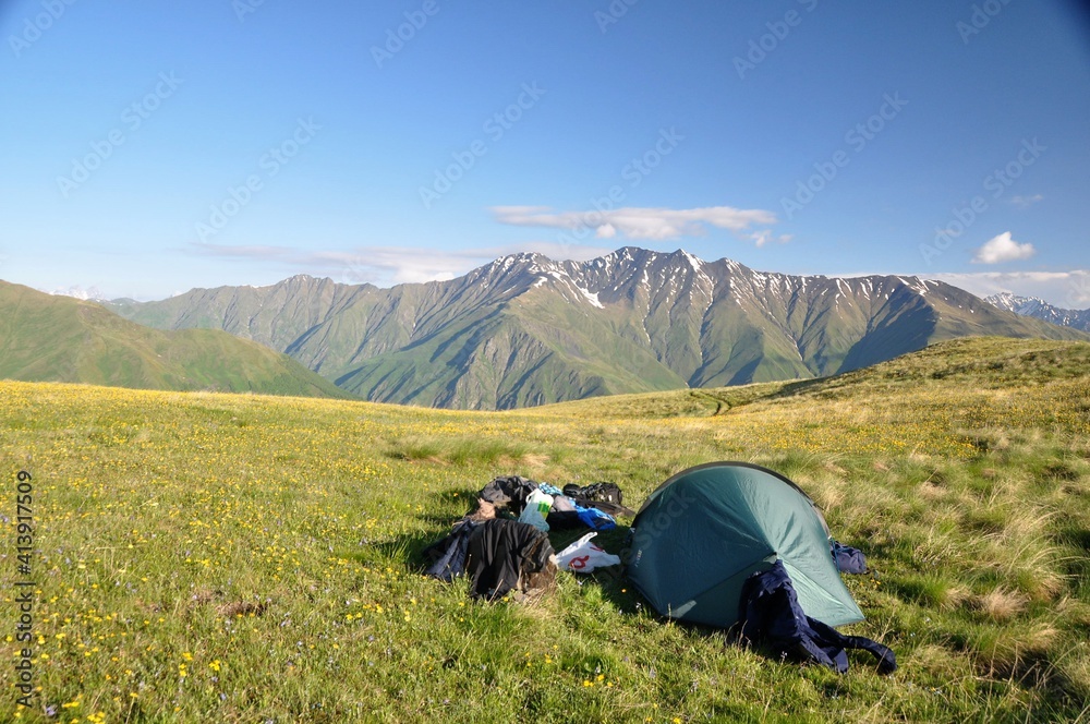 Tent pitched on a meadow in mountains