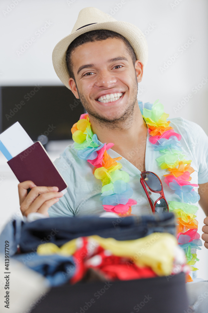 portrait of a happy young man holding passport portrait of a happy young man holding passport