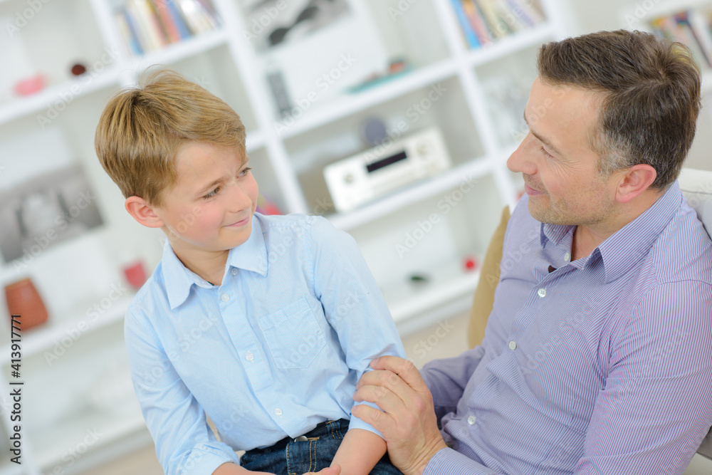 Fototapeta premium Child sat of lap of adult