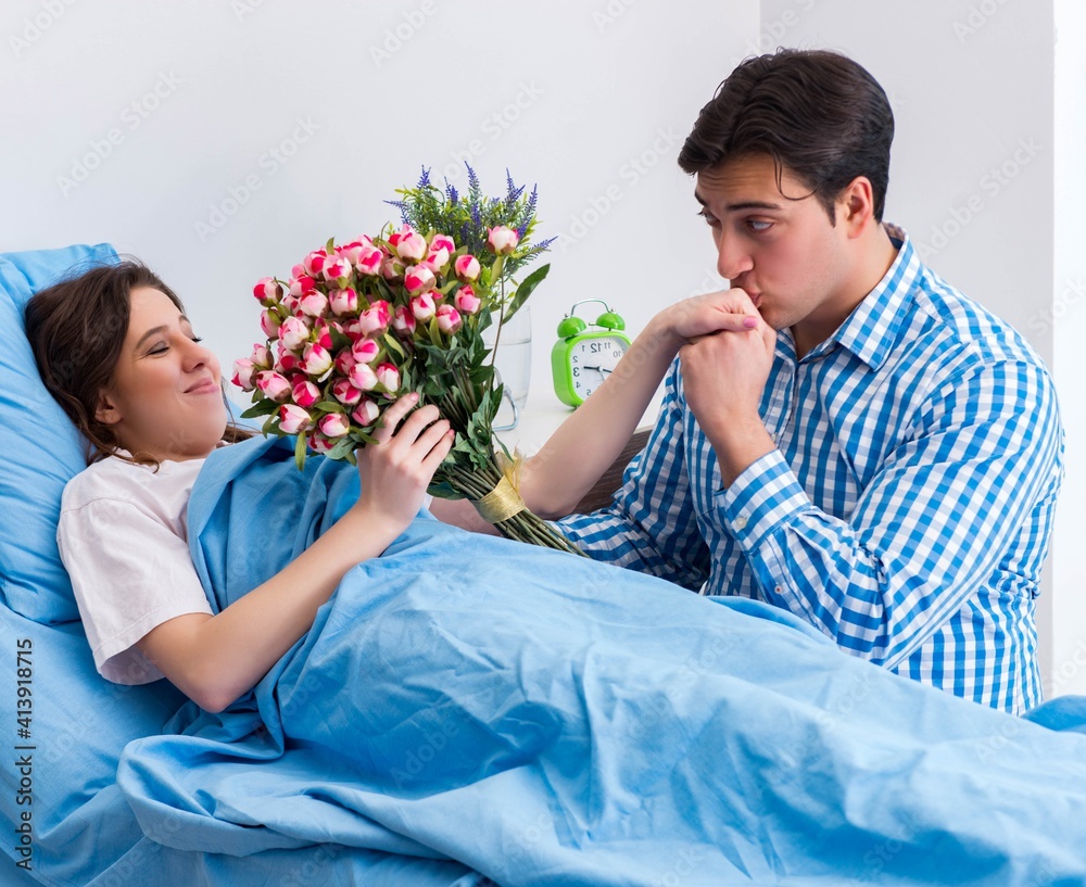 Caring loving husband visiting pregnant wife in hospital Caring loving husband visiting pregnant wife in hospital