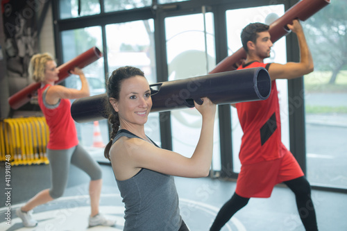 exercise class working out using cylindrical accessory