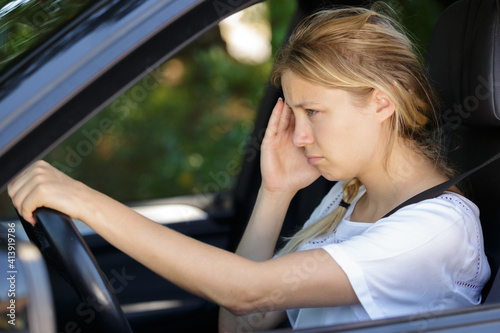 woman having headache in a car © auremar