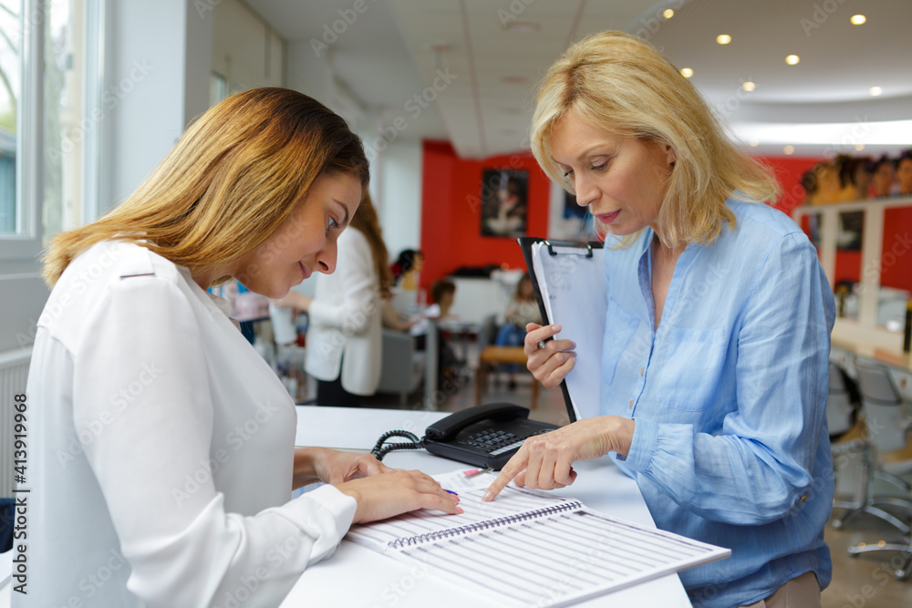 boss with women secretary busy reviewing appointments