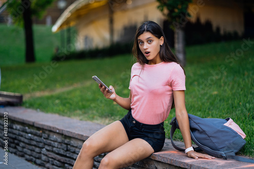 Beautiful young hipster woman using smart phone © teksomolika