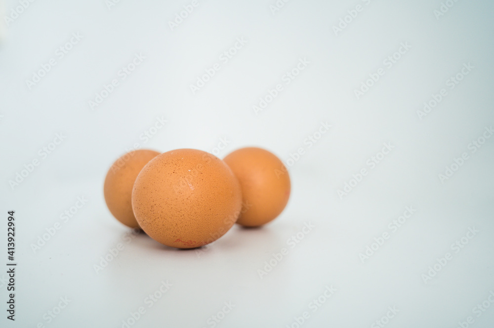 Close up of fresh raw brown chicken eggs on white table. Ingridients for healthy food. Top view.