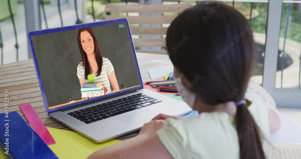 Caucasian schoolgirl in face mask using laptop on video call with female teacher Caucasian schoolgirl in face mask using laptop on video call with female teacher