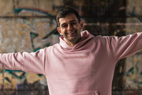 happy young man on the street with open arms