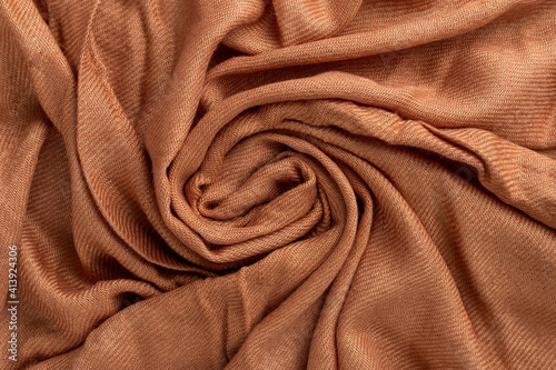 Crumpled linen cloth texture. Wrinkled textile. Brown