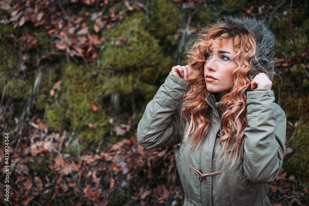 Portrait of young woman with curly hair in winter jacket Portrait of young woman with curly hair in winter jacket