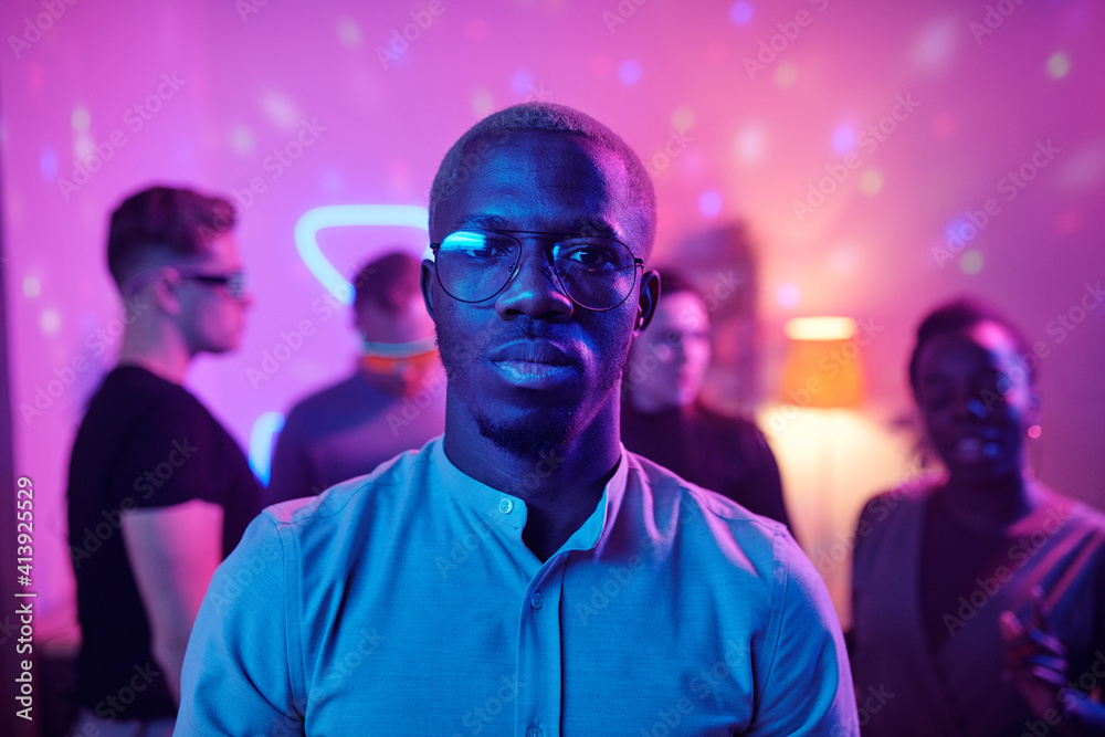 Serious guy of African ethnicity in casualwear and eyeglasses looking at you Serious guy of African ethnicity in casualwear and eyeglasses looking at you