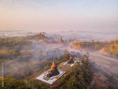 Aerial view of Ratana San Rwe and Ratana Man Kin Pagodas surrounded by forest with mist, Mrauk-U Township, Myanmar. photo