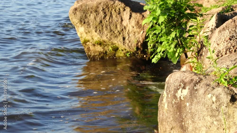 Water lapping at some rocks along the shore of a lake. Water lapping at some rocks along the shore of a lake.