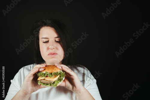 Woman on diet eating tasty hamburger
