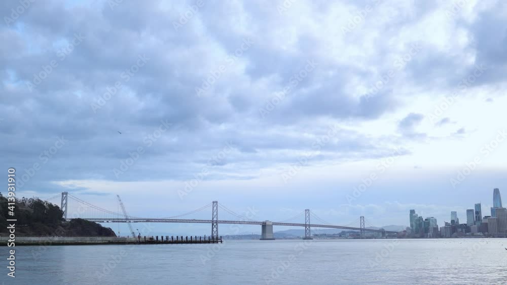 Bridge and the pacific ocean next to a cityscape in California Bridge and the pacific ocean next to a cityscape in California