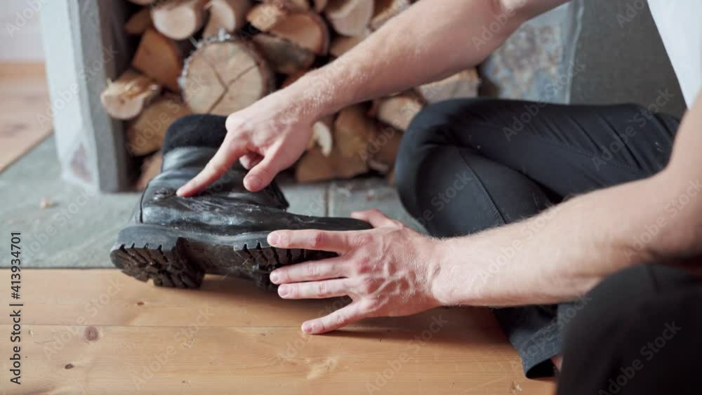 Man Polishes A Black Boot With One Finger. close up Man Polishes A Black Boot With One Finger. close up