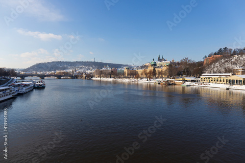 Snowy Prague Lesser Town with Prague Castle above River Vltava in the sunny Day   Czech republic