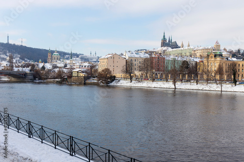 Snowy Prague Lesser Town with Prague Castle above River Vltava in the sunny Day , Czech republic