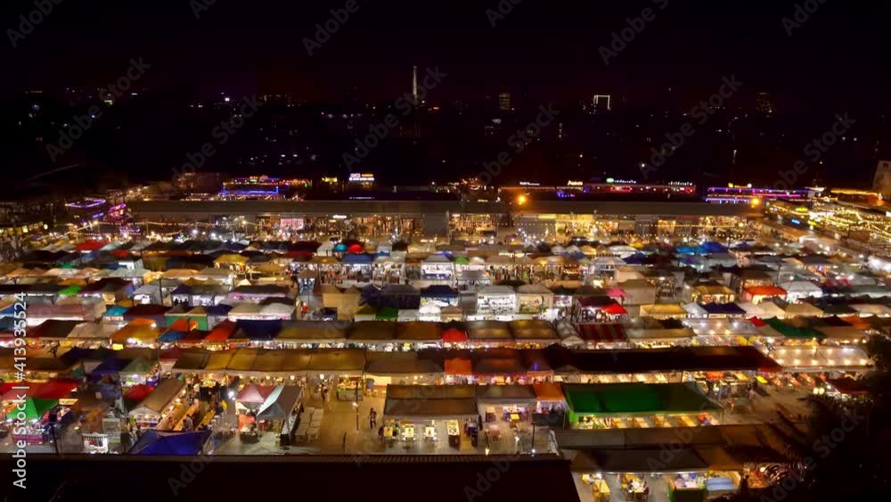 4k Wide Static Top view of Train Night Market Ratchada (Talad Rot Fai) in Bangkok, Thailand, Asia. BKK nightlife. Beautiful Asian Night Market with plenty of shops with colorful canvas roofs at night. 4k Wide Static Top view of Train Night Market Ratchada (Talad Rot Fai) in Bangkok, Thailand, Asia. BKK nightlife. Beautiful Asian Night Market with plenty of shops with colorful canvas roofs at night.