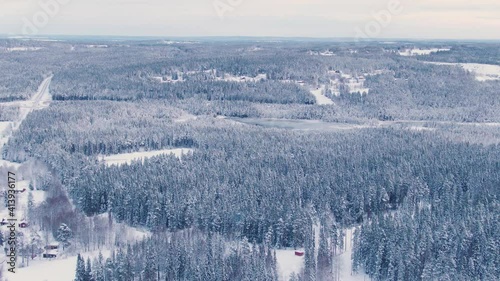 Wide panoramic dolly zoom aerial of vast Scandinavian snowy landscape photo