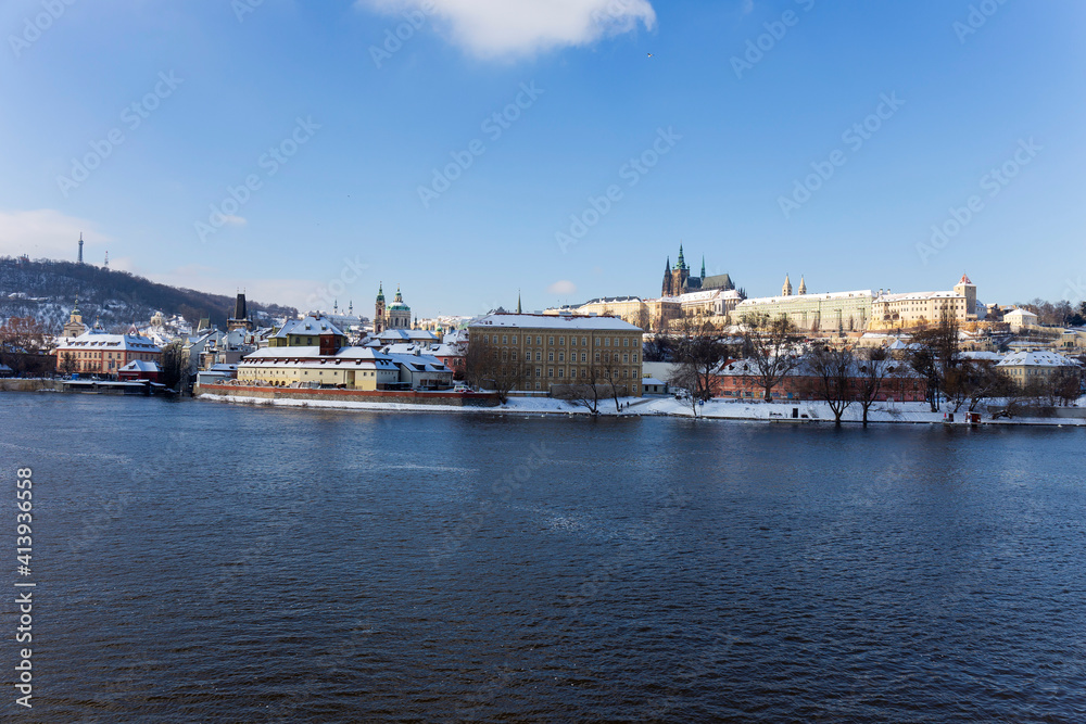 Snowy Prague Lesser Town with Prague Castle above River Vltava in the sunny Day , Czech republic