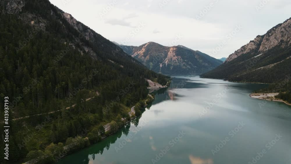 Aerial Drone Shot of a curvy street and a beautiful lake, Plansee in Austria, Österreich, nature, national park, relaxing, Slow Motion Aerial Drone Shot of a curvy street and a beautiful lake, Plansee in Austria, Österreich, nature, national park, relaxing, Slow Motion