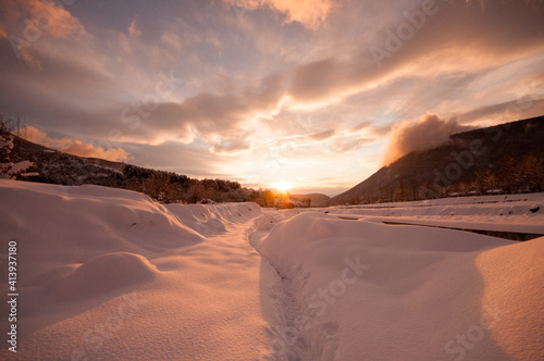 Majestic sunset in the winter mountains landscape. Dramatic sky. Azerbaijan nature.