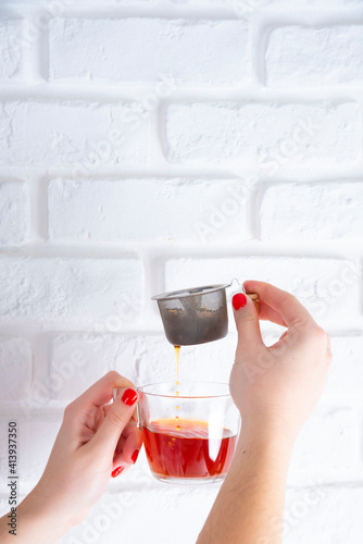 White woman hands with red nails, Cup of Tea, on white background with chocolate Tablet, croissant, chocolate puff pastry, sugar puff pastry, whole grain panela