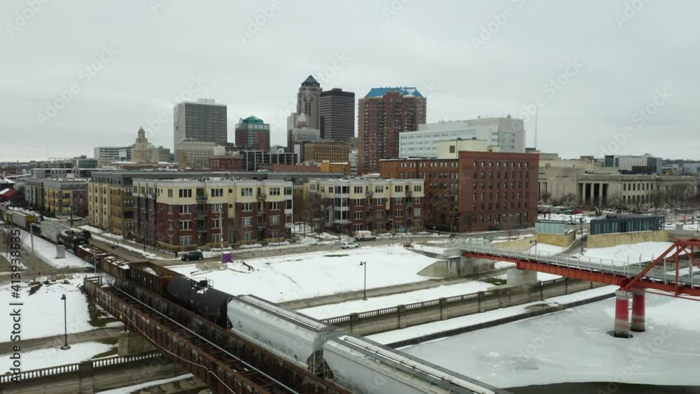 Des Moines, Iowa in Winter. Train Passing in Foreground Des Moines, Iowa in Winter. Train Passing in Foreground