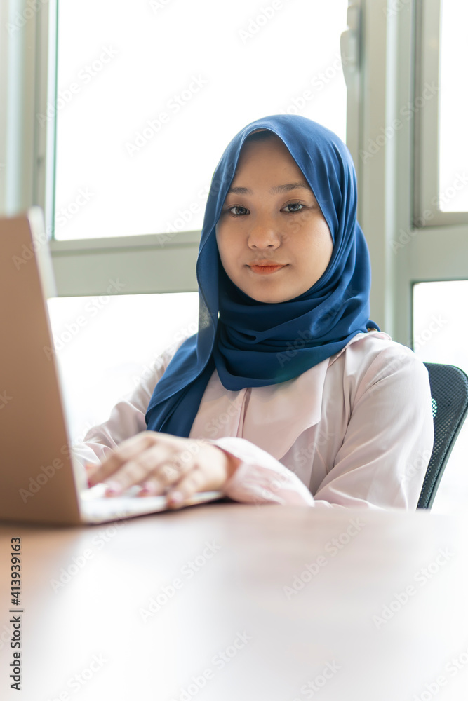 Malay lady using laptop at home Malay lady using laptop at home