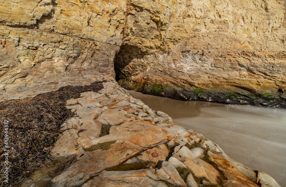 A small cave in the bay of shark fin, beautiful beach landscape on the coast of the California Highway, ocean, rocks, great sky, clear sunny weather.