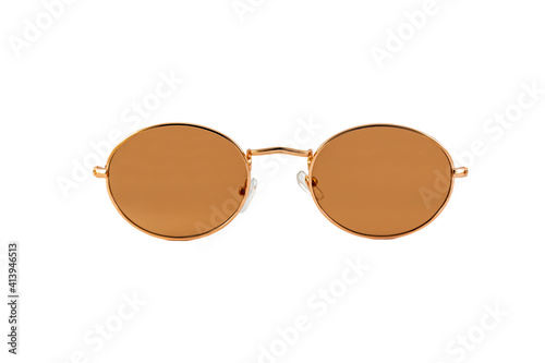 Street style round, small, orange sunglasses with matte lenses and thin golden wrap around frames isolated on white background. Front view.
