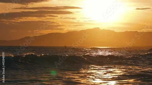 Man doing stand up paddle boarding in a nice sun bet