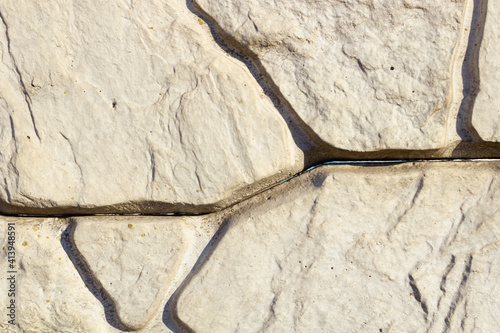 several deep cracks in white stones