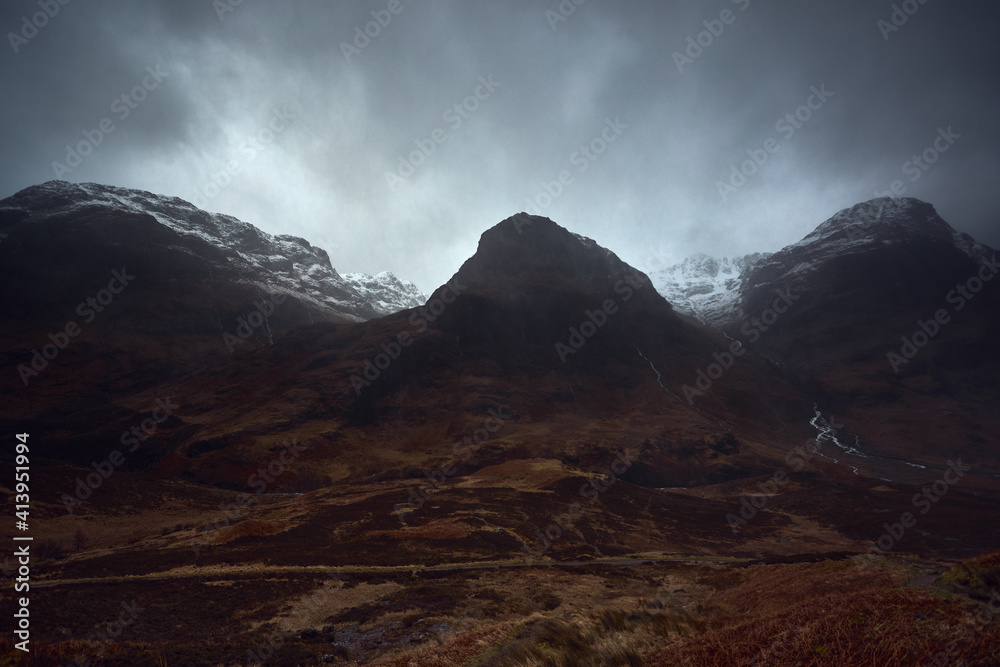 Three Sisters Mountains, Glencoe. Bidean nam Bian in the picture. . Snowy atmosphere in winter, after a big storm. Rain in the environment. Horrible February day in full red alert for weather
