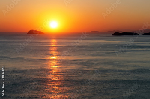 light reflection in water during sunset with big sun in the background