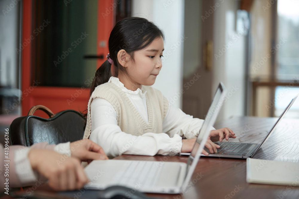 at home schoolgirl do homework, focused little Asia girl watch video lesson using laptop app, interested in on-line web virtual class studying from at home, homeschooling concept at home schoolgirl do homework, focused little Asia girl watch video lesson using laptop app, interested in on-line web virtual class studying from at home, homeschooling concept
