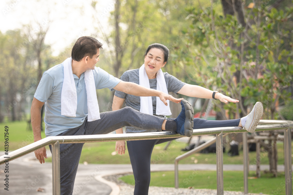 Asian couple exercise in city park on morning concept family, love, freedom , life insurance , retire , healthy strong