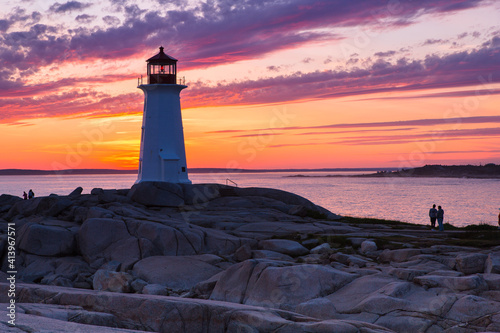 A dramatic sunset at Peggy s Cove Lighthouse Atlantic Coast Nova Scotia Canada. The most visited tourist location in the Atlantic Canada and famous Lighthouse captured with vibrant colors during sunse