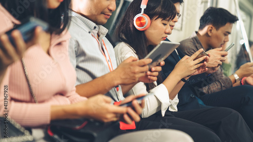 Canvastavla Young people using mobile phone in public underground train
