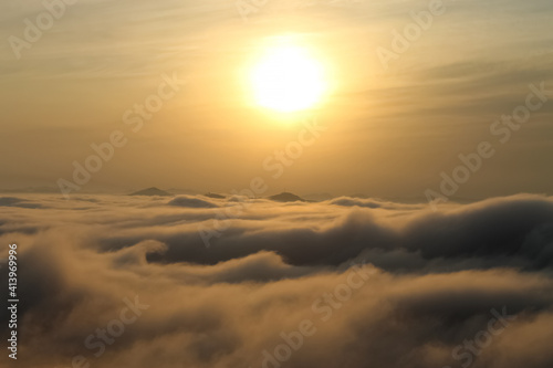 Sun at sunset over the clouds
