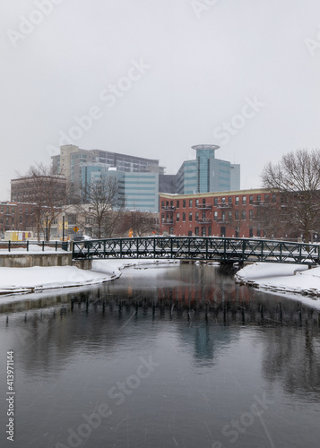 Kalamazoo, Michigan, USA - February 5 2021: Downtown Kalamazoo in snow. view from Arcadia Creek playground. Black and white.