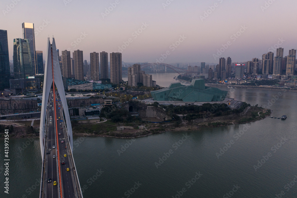 Aerial view of Chongqing at sunset with Qiansimen Bridge and Grand Theatre on foreground