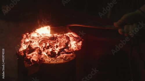 Japanese Swordsmith craftsman cuts the steel into small pieces with close-up angle. photo