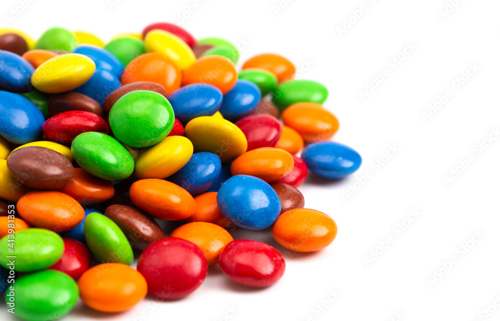 Pile of Rainbow Colored Candy Coated Chocolate Buttons Isolated on a White Background Pile of Rainbow Colored Candy Coated Chocolate Buttons Isolated on a White Background