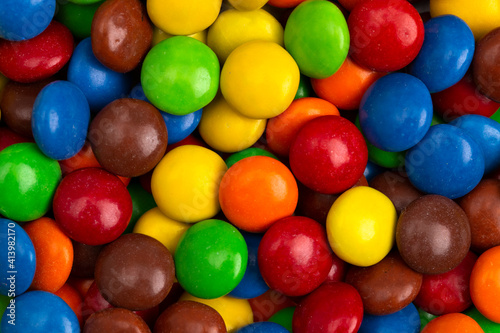 Background of Rainbow Colored Candy Coated Chocolate Buttons